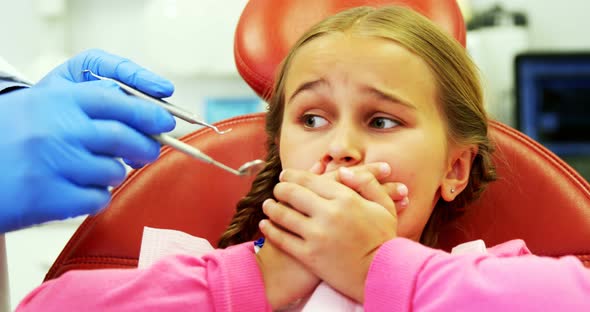 Young patient scared during a dental check-up alt