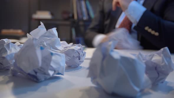 Office worker crumpling paper. alt