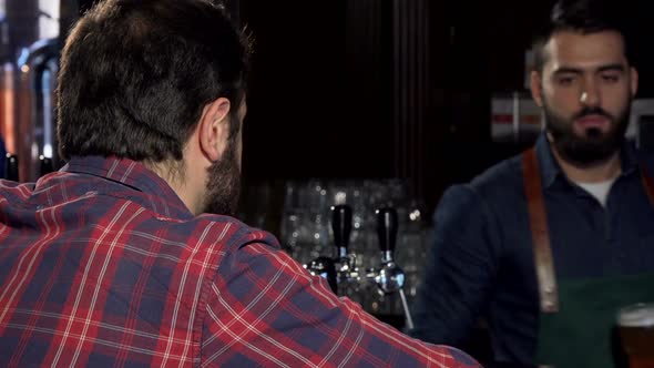 Male Customer Smiling To the Camera, Having Delicious Beer at the Pub alt