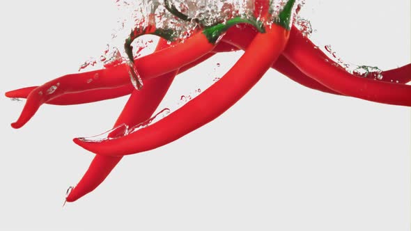 Super Slow Motion Chilli Pepper Falls Under the Water with Air Bubbles alt