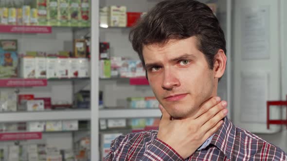 Handsome Young Man Coughing Having Sore Throat Standing at the Pharmacy alt