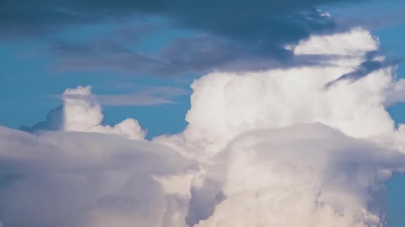Timelapse of White Puffy Cumulus Clouds Forming on Summer Blue Sky alt