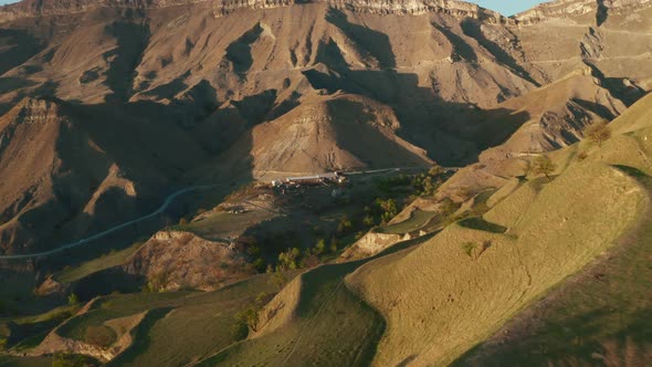 Aerial view of mountain hills, terraces on sunset, countryside landscape with tractor alt