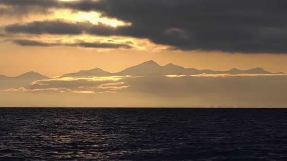 Seascape - Clouds Illuminated by Rays of Sun, Floating Across Sky. Time Lapse