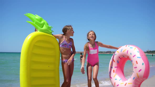 Little Girls Having Fun at Tropical Beach During Summer Vacation Playing Together alt