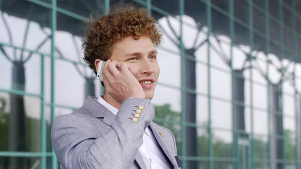 Successful Business Man Young Male Entrepreneur Standing Outside in Suit Calling Someone While