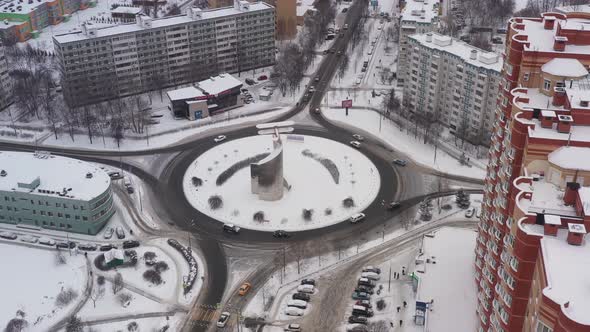 A Roundabout with a Monument to an Airplane in a Modern Area in Winter