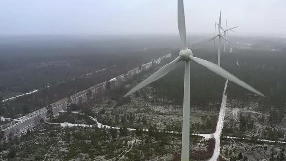 Beautiful Drone Point of View of Wind Generators Next to a Road in Finland