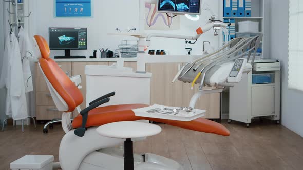 Interior of Modern Equipped Dental Office with x Ray on Monitors alt