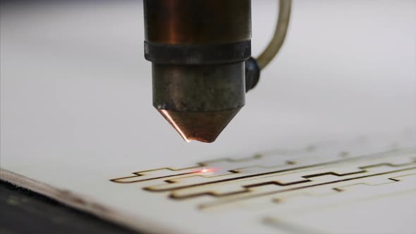 Industrial Laser Is Cutting a Pattern on a Plywood Sheet