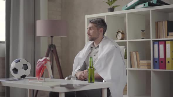 Portrait of a Handsome Positive Man Taking Off Hite Robe and Preparing To Watch Football and alt