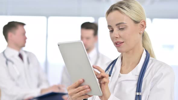 Portrait of Professional Female Doctor Using Tablet in Office alt