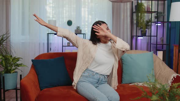 Trendy Cheerful Positive Woman Dancing and Moving to Rhythm Making Dub Dance Gesture at Modern Home alt