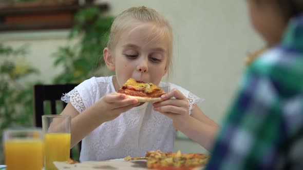 Girl Eating Pizza With Brother in Cafe, Celebrating Birthday, Favourite Food alt