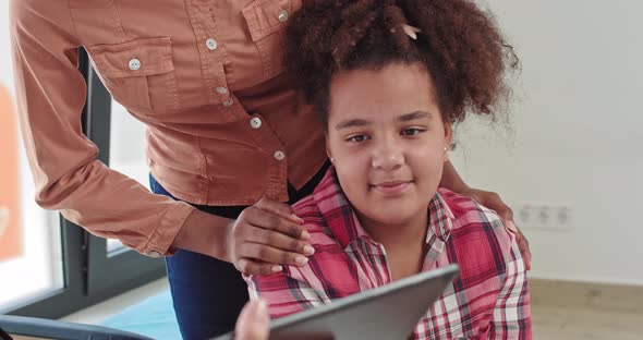 Close Up of Beautiful Baby Girl with Curly Hair African American in Mother's alt