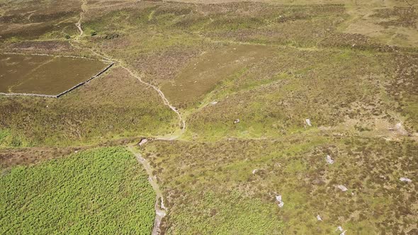 Aerial view of dirt road for off road activities in Dartmoor National Park, England. alt