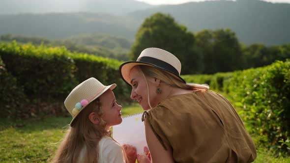 Mother and Daughter Spending Time Outdoors and Drawing alt
