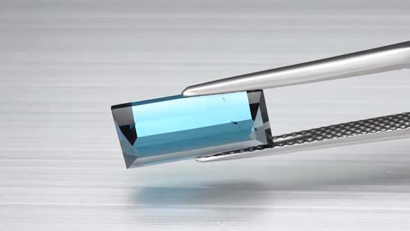 Natural London Blue Topaz Baguette Cut in the Turning Tweezers