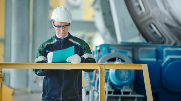 Engineer Signing a Document in Industrial Factory alt