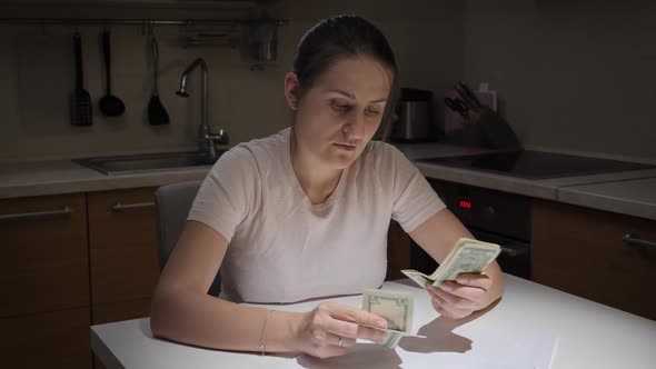 Portrait of Stressed Young Woman Having Financial Problems Counting Her Few Money alt