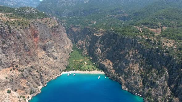 Deep Rocky Narrow Valley by the Turquoise Sea alt