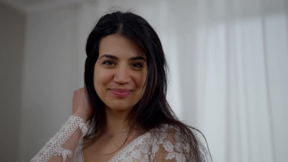 Closeup Portrait of Happy Smiling Young Middle Eastern Woman in White Beautiful Wedding Dress Posing alt