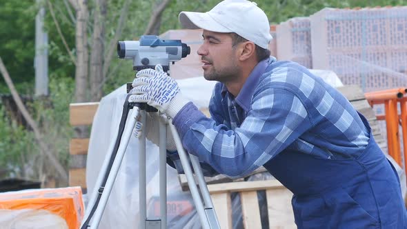 Worker Makes Measuring in Construction Laser Level