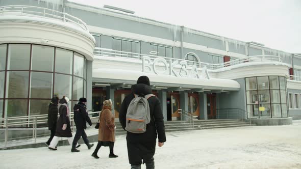 A Passenger Goes to the Train Station in Winter