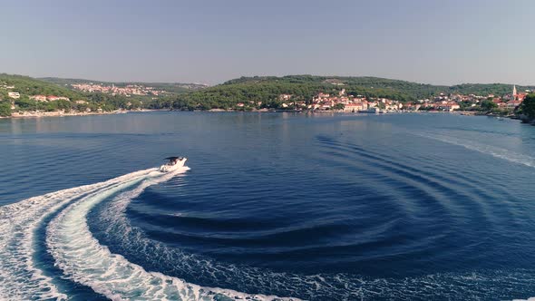 Aerial view of speed boat sailing at Adriatic sea near Brac island, Croatia. alt