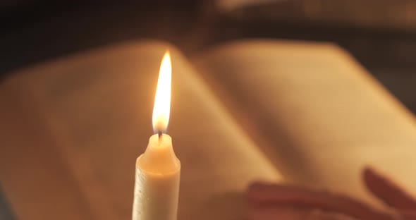 A Man Reads and Turns Over the Yellow Pages of an Old Book alt