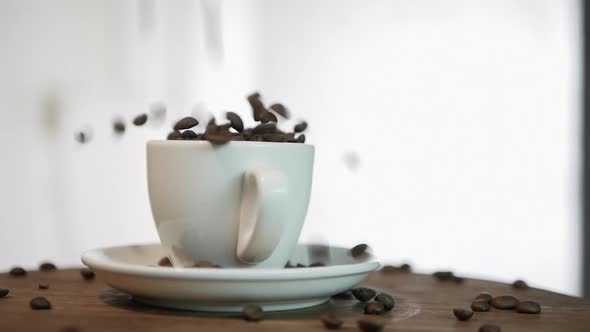 Slow Motion Coffee Beans Fall Into A Coffee Cup, In A Coffee Cup On A Turntable alt