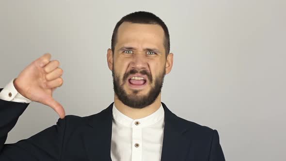 Young Handsome Businessman Shows Thumb Down Expressing His Displeasure