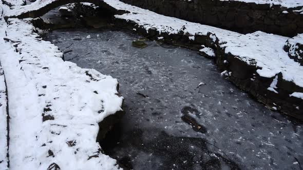 Frozen pond in winter park. alt
