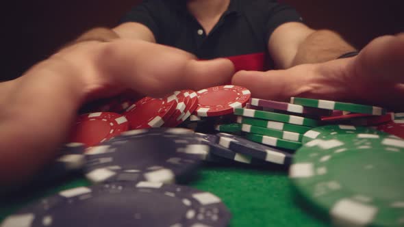 Male Player Moving Casino Chips on Poker Table Close Up