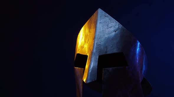 Iron Spartan Helmet Isolated in Darkness. alt