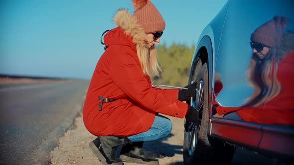 Woman Check Car Tire Pressure. Vehicle Trouble On Road On Vacation Trip. Female Trying Fix Car Tire. alt