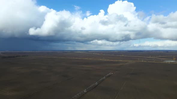 Aerial drone view drip irrigation watering system in agricultural farm field alt