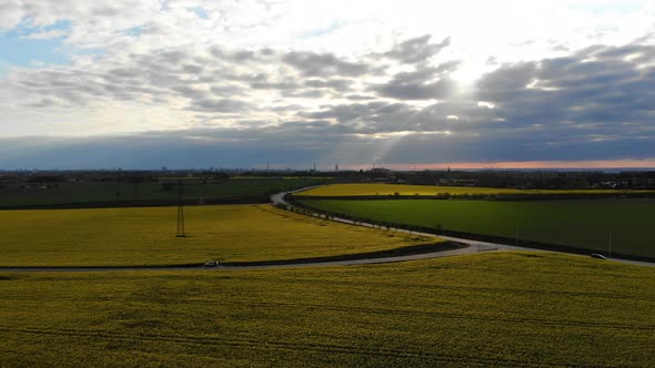 Drone view backwards going, rapsmark in south Sweden at sunset. Malmö from far away alt
