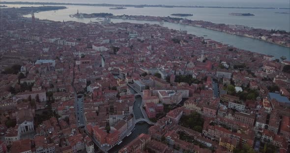 Wide aerial shot of moving towards San Marco from above at dusk, Venice, Italy alt