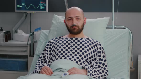 Potrait of Hospitalized Sick Man with Nasal Oxygen Tube Having Respiratory Disorder alt