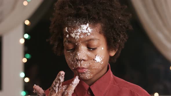 Kid Licks Cake-smeared Fingers. alt