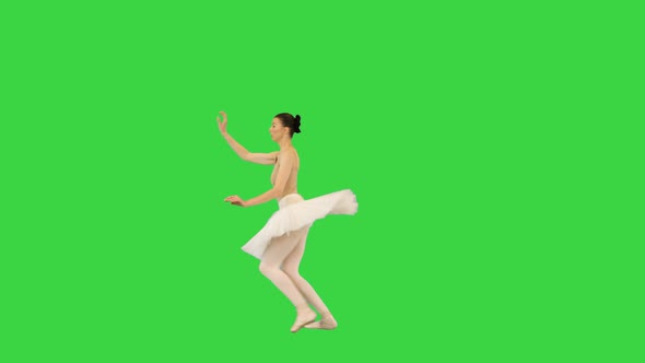 Young Ballerina Performing Grand Jete on a Green Screen Chroma Key alt