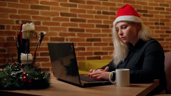 Business woman working on laptop computer at christmas holiday alt