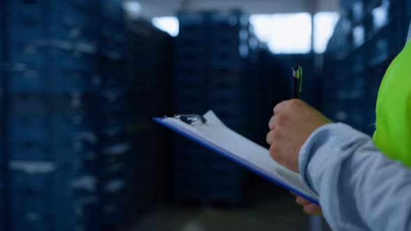 Warehouse Worker Making Notes Collecting Information Analysing Shipment Process alt