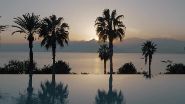 Outdoor pool on resort and nature landscape at sunset, Turkey alt