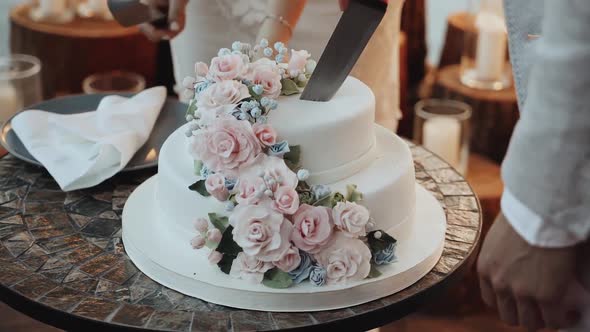 Detail of Wedding Cake Cutting By Newlyweds Wedding Cake Decorated with Flowers Pastel Pink Roses alt