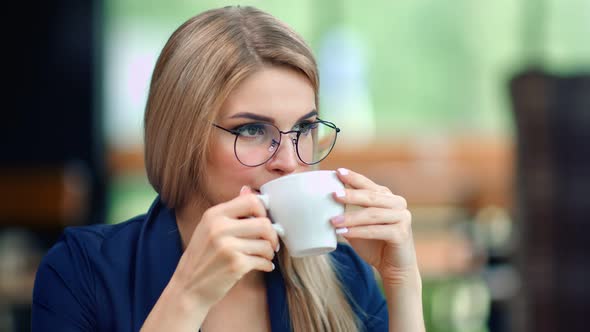Pensive Beautiful Business Woman Drinking Coffee From Cup Relaxing Enjoying Break Medium Closeup alt
