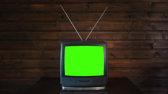 Old Tv With Green Screen On Wooden Background