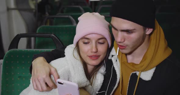 Close Up of Young Couple Looking at Smartphone Screen While Watching Video. Happy Girlfriend and alt