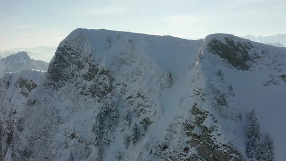 Drone flying over mountain summit and reveal small tunnel systems on top alt